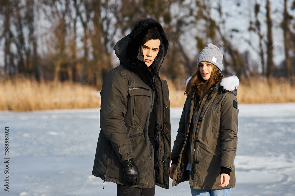 happy couple hugging and laughing outdoors in winter happy couple hugging and laughing outdoors in winter