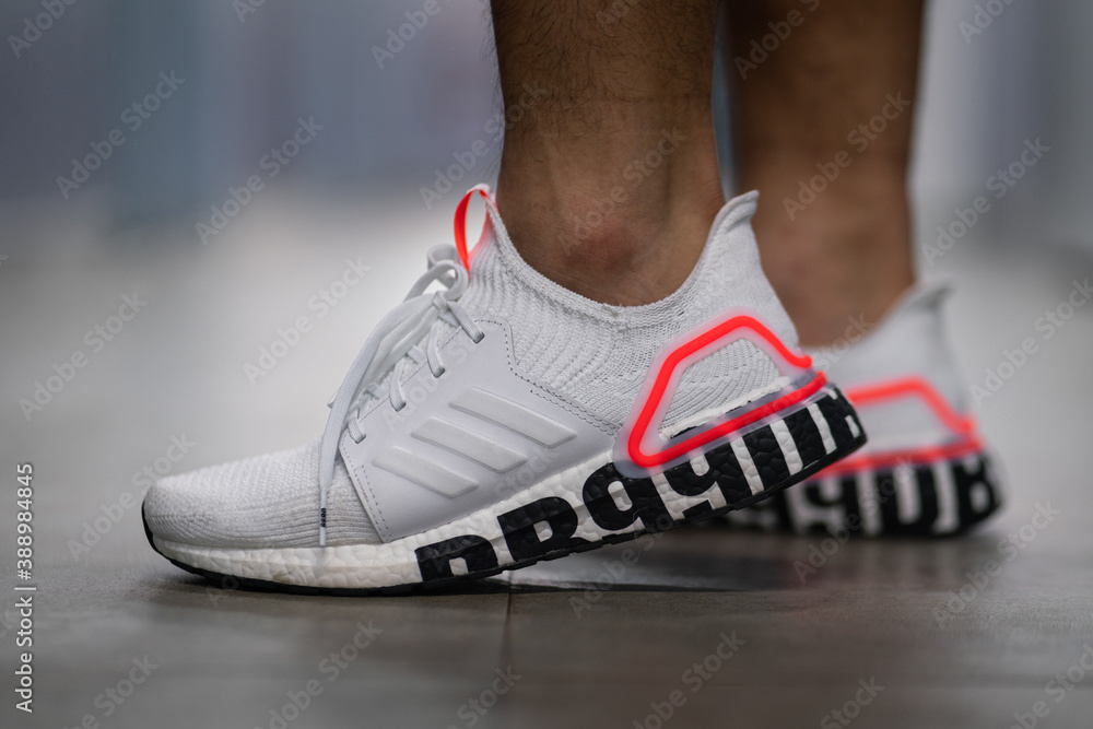 Bangkok / Thailand - December 2019 : A runner is wearing Adidas Ultraboost  19 limited edition colorway which is inspired by David Beckham's story. Ultraboost  19 is the most famous running shoe model. Stock-Foto | Adobe Stock