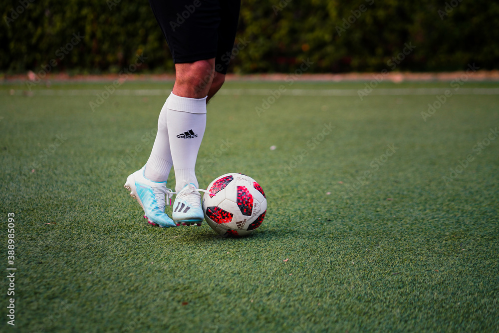 Bangkok/Thailand - December 2019 : A football player is practice to  dribbling the ball on local turf