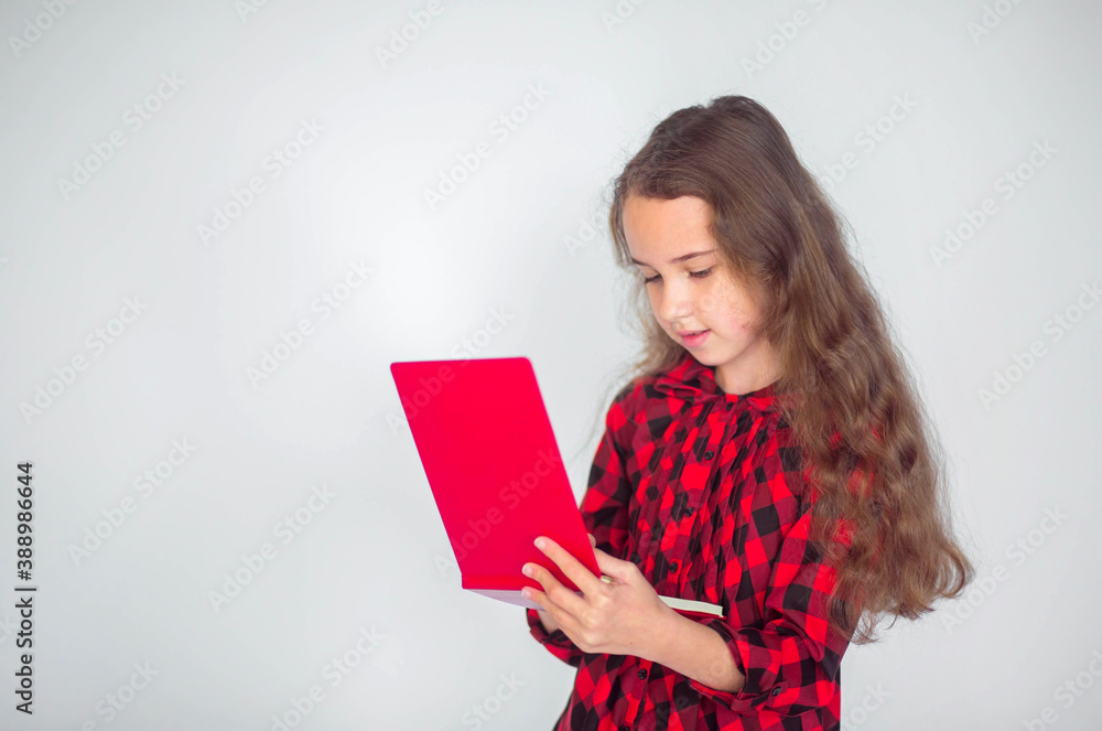Happy cute curly pupil girl with folder on isolated background. Back to school concept Happy cute curly pupil girl with folder on isolated background. Back to school concept