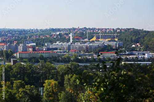 Prague. View of the urban districts Bubenec, Dejvice and the Juliska stadium from the zoo in Troy. Green trees in the foreground. photo
