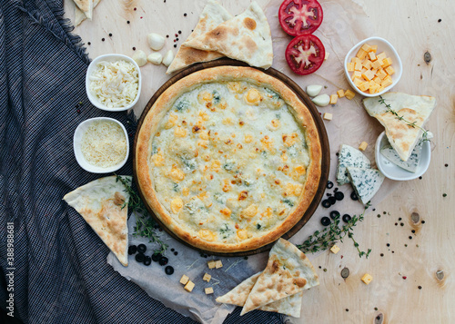 Tasty italian pizza made from an authentic recipe. Mozzarella topping mealted on top. Sauce aside. Professional product photography. photo