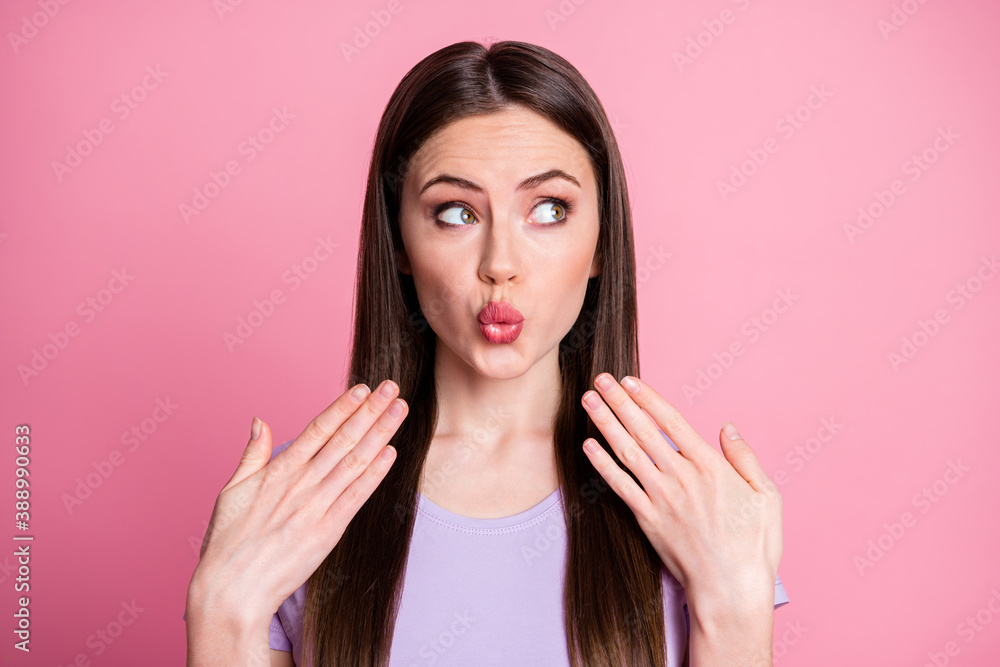 Closeup photo of attractive funny lady long hairdo raise arms near mouth send shy flirty air kisses look side up empty space wear casual violet t-shirt isolated pink pastel color background Closeup photo of attractive funny lady long hairdo raise arms near mouth send shy flirty air kisses look side up empty space wear casual violet t-shirt isolated pink pastel color background