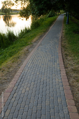 footpath alley of paving slabs in the park