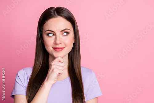 Closeup photo of charming lady long hairdo look side empty space finger chin thinking creative idea intelligent person wear casual purple t-shirt isolated pastel pink color background