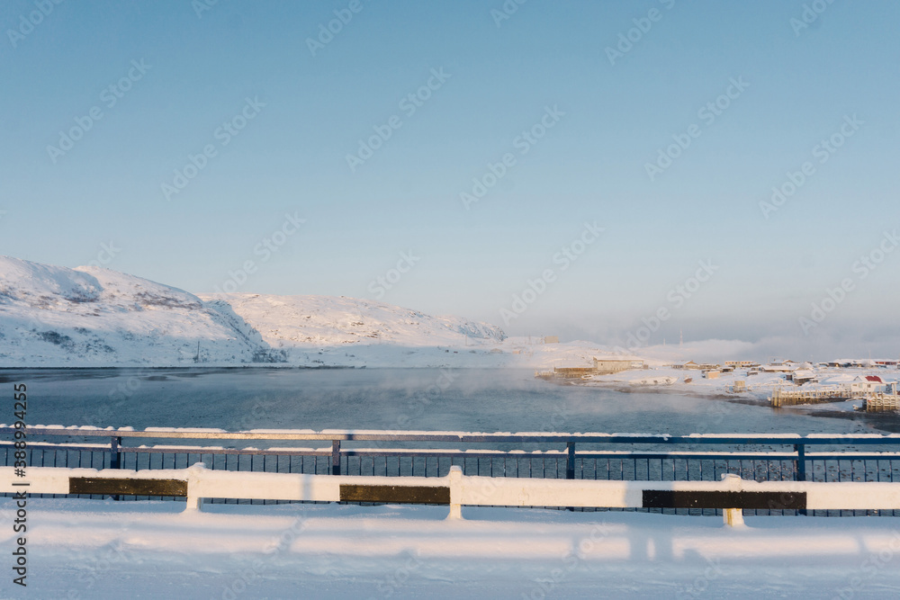 foggy Bay below the bridge during severe frosts in the snowy winter over the Arctic circle