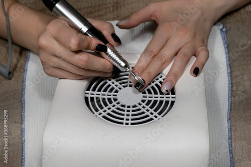 Beauty and healthcare concept. Hardware manicure, removing gel polish from nails at home, top view