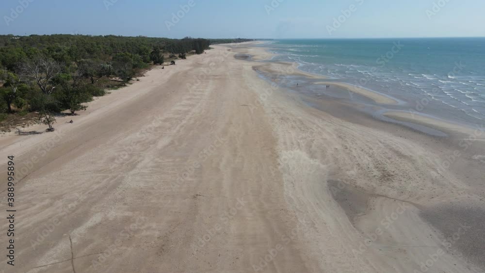Slow drone shot moving away from beach towards water at Lee Point in Northern Territory Slow drone shot moving away from beach towards water at Lee Point in Northern Territory