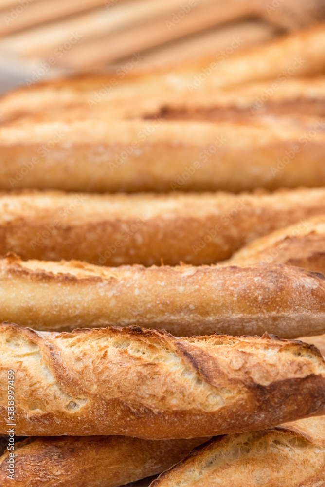 Freshly baked French baguettes lie on a light-colored surface. Rustic handicraft bread, handmade Freshly baked French baguettes lie on a light-colored surface. Rustic handicraft bread, handmade