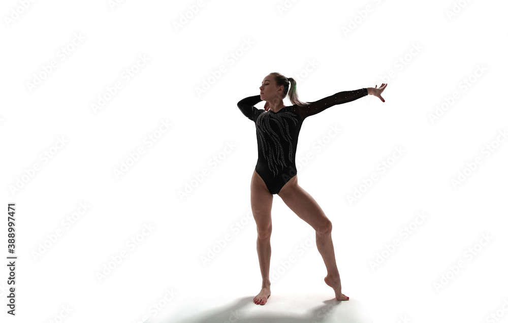 Female gymnast doing a complicated trick isolated on white. Female gymnast doing a complicated trick isolated on white.