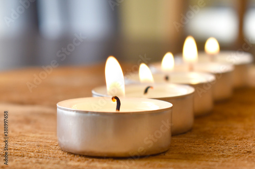 Fotografie Tea light candle on wood.