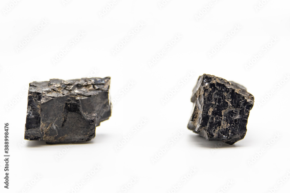 Natural black coals isolated in white background. Two dirty coals stones. Natural black coals isolated in white background. Two dirty coals stones.