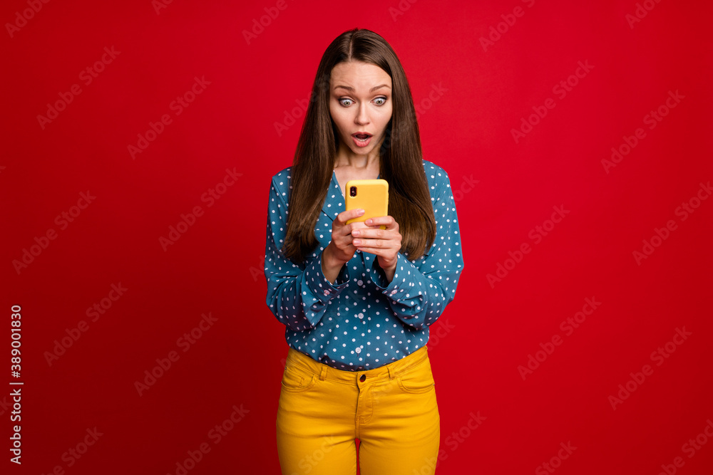 Portrait of attractive focused worried girl using gadget web service fake news feedback isolated bright red color background Portrait of attractive focused worried girl using gadget web service fake news feedback isolated bright red color background