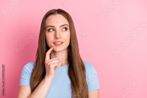Photo portrait of woman touching chin with finger thinking isolated on pastel pink colored background