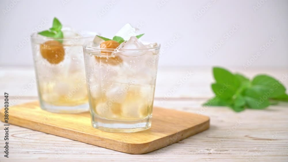 iced plum juice with soda and peppermint on wood table - refreshment drink iced plum juice with soda and peppermint on wood table - refreshment drink