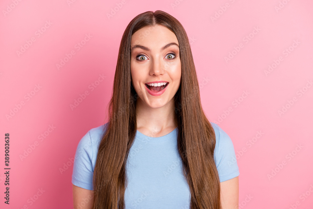 Photo portrait of amazed shocked girl with long brown hair smiling cheerfully isolated on pastel pink color backgroung Photo portrait of amazed shocked girl with long brown hair smiling cheerfully isolated on pastel pink color backgroung