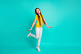 Full length photo of pretty kid girl standing isolated over turquoise color background
