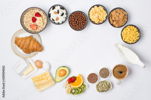Various type of breakfast, porridge, flakes, fruits, milk, coffee, croissant