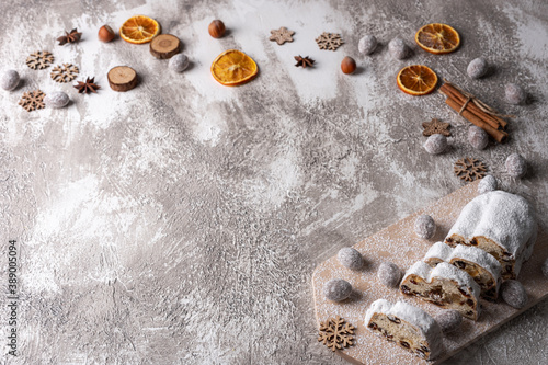 Christmas background with stollen, nuts, spices and fruits. Top view with copy space. Empty place for a text.