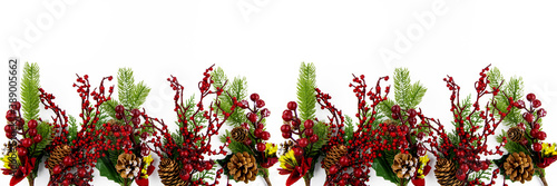 Christmas flat composition on a white background decorative branches with fir branches, cones and red berries. Banner.