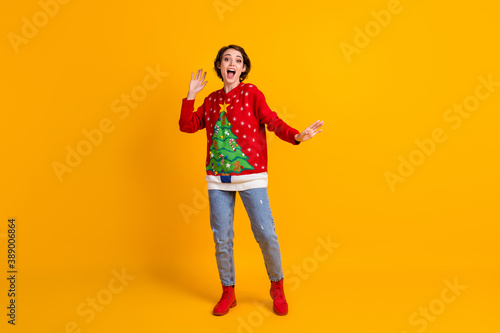 Full length photo of excited crazy funky cool girl in sweater with christmas tree dance x-mas discotheque isolated over bright shine yellow color background