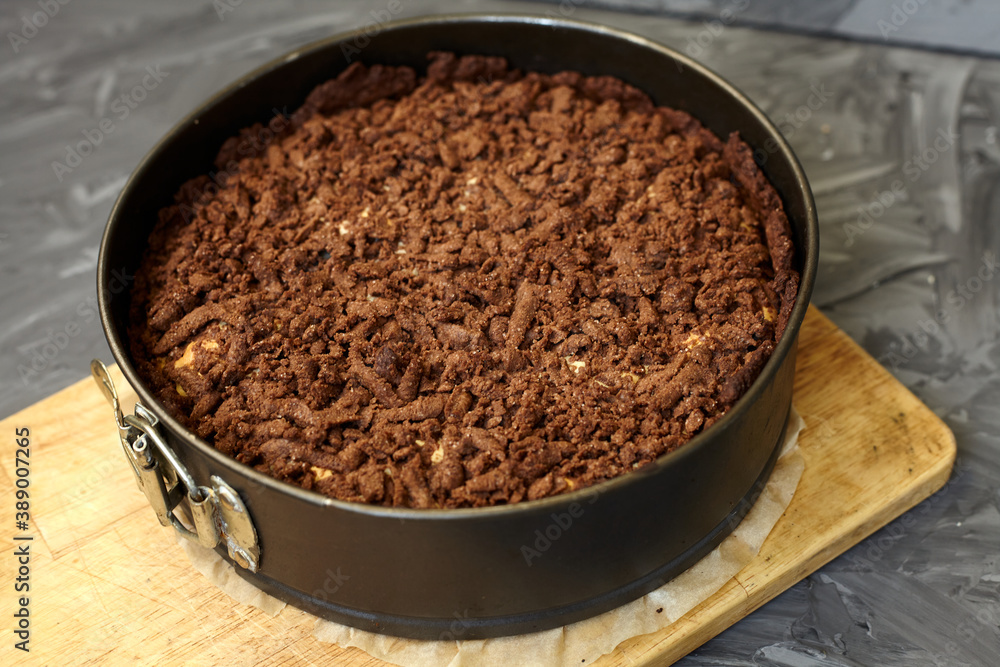 Chocolate cake in a split baking dish. Homemade cake. Pie on a grey background Chocolate cake in a split baking dish. Homemade cake. Pie on a grey background