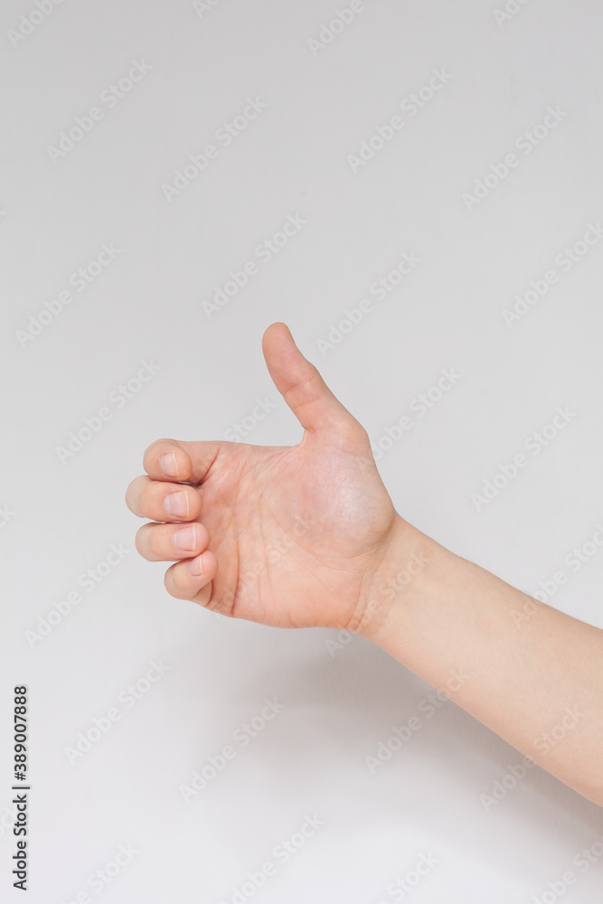 Close up hand holding something like a bottle or can isolated on white background. Close up hand holding something like a bottle or can isolated on white background.