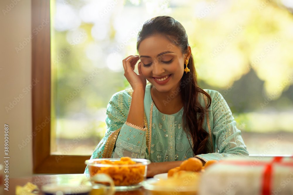 A beautiful woman smiling during Diwali celebrations. A beautiful woman smiling during Diwali celebrations.