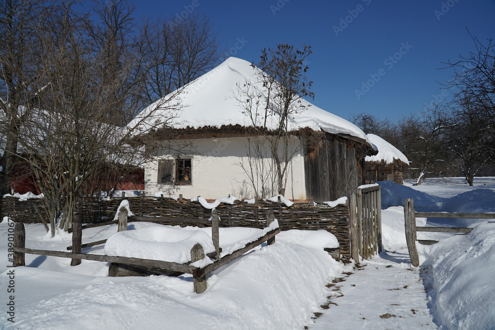 Wonderful winter landscape with wooden houses. Winter village. Frosty trees in warm sunlight. Picturesque natural landscapes Wonderful winter landscape with wooden houses. Winter village. Frosty trees in warm sunlight. Picturesque natural landscapes
