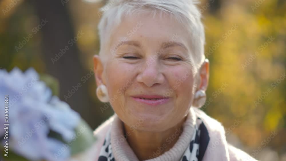 Portrait of beautiful aged woman sitting outdoors and talking to man on date Portrait of beautiful aged woman sitting outdoors and talking to man on date