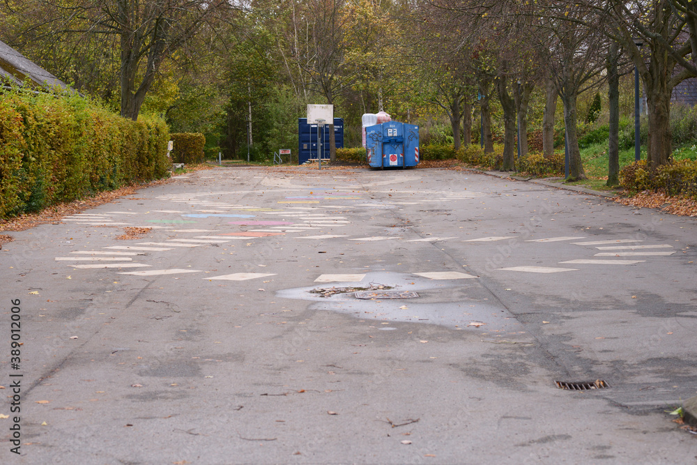 A empty lot at a school with a basketball net A empty lot at a school with a basketball net