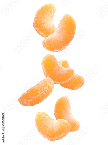Fresh ripe tangerine pieces falling on white background