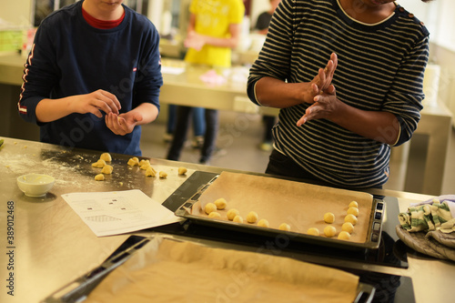Kids baking cookies in school home ed