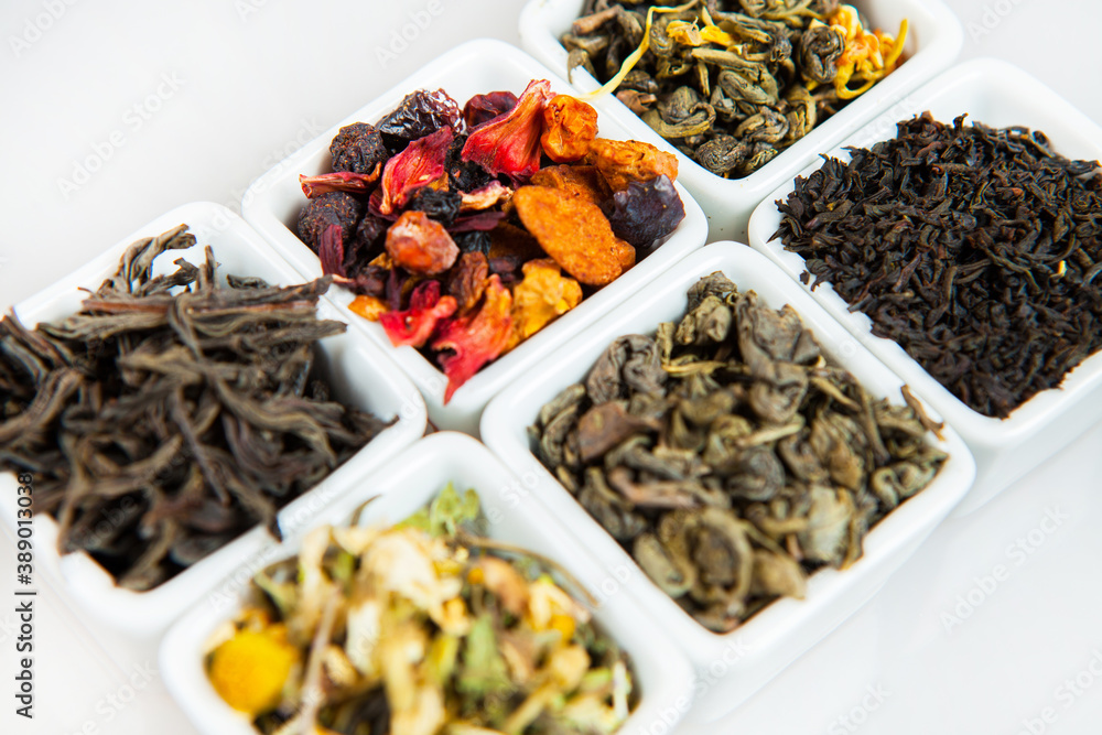 Assortment of dry tea. Various kinds of tea isolated on white.Different kinds of tea leaves. Tea composition with different kind of tea. Tea concept. Tea leaves Assortment of dry tea. Various kinds of tea isolated on white.Different kinds of tea leaves. Tea composition with different kind of tea. Tea concept. Tea leaves
