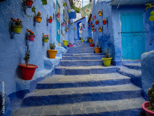 Chefchaouen the Blue city in Morocco with colourful pots decorating a blue stairwell photo