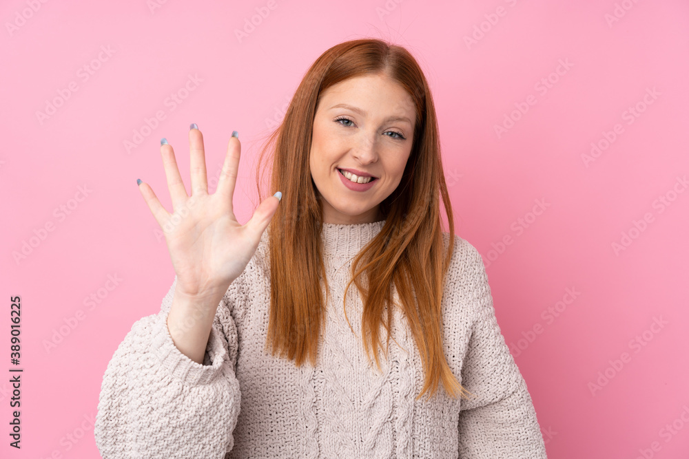 Young redhead woman over isolated pink background counting five with fingers