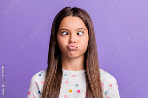 Photo portrait of silly girl grimacing looking at nose pouting isolated on vivid violet colored background