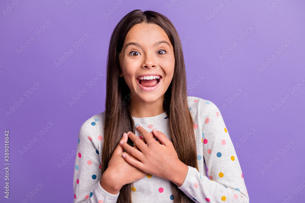 Photo portrait of laughing girl touching chest with hands isolated on vivid violet colored background Photo portrait of laughing girl touching chest with hands isolated on vivid violet colored background