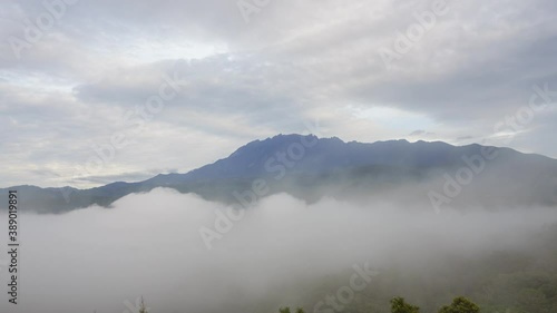 Time lapse MOUNT KINABALU foggy or the clouds while sunrise sky. Sea of clouds. Foggy valley mount ridge nature. Taken At RANAU, SABAH, BORNEO , MALAYSIA photo