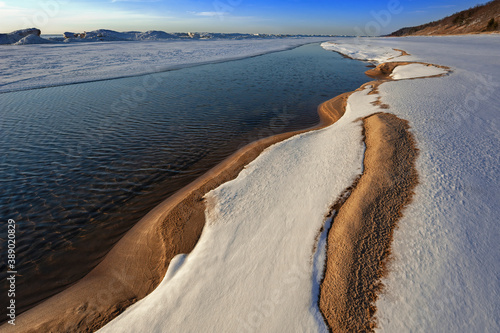 Winter landscape of the frozen shoreline of Lake Michigan near sunset, Saugatuck Dunes State Park, Michigan, USA photo