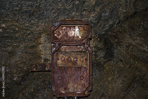 Obraz na płótnie Old and heavily rusted electrical box in an abandoned mine w salonie
