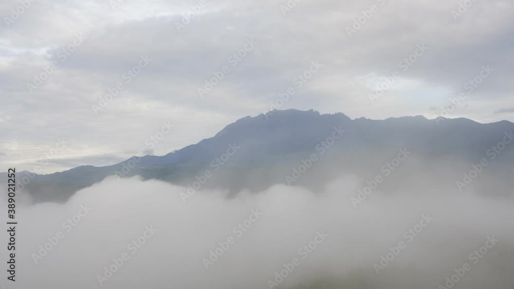Time lapse MOUNT KINABALU foggy or the clouds while sunrise sky. Sea of clouds. Foggy valley mount ridge nature. Taken At RANAU, SABAH, BORNEO , MALAYSIA. time lapse motion pan right Time lapse MOUNT KINABALU foggy or the clouds while sunrise sky. Sea of clouds. Foggy valley mount ridge nature. Taken At RANAU, SABAH, BORNEO , MALAYSIA. time lapse motion pan right