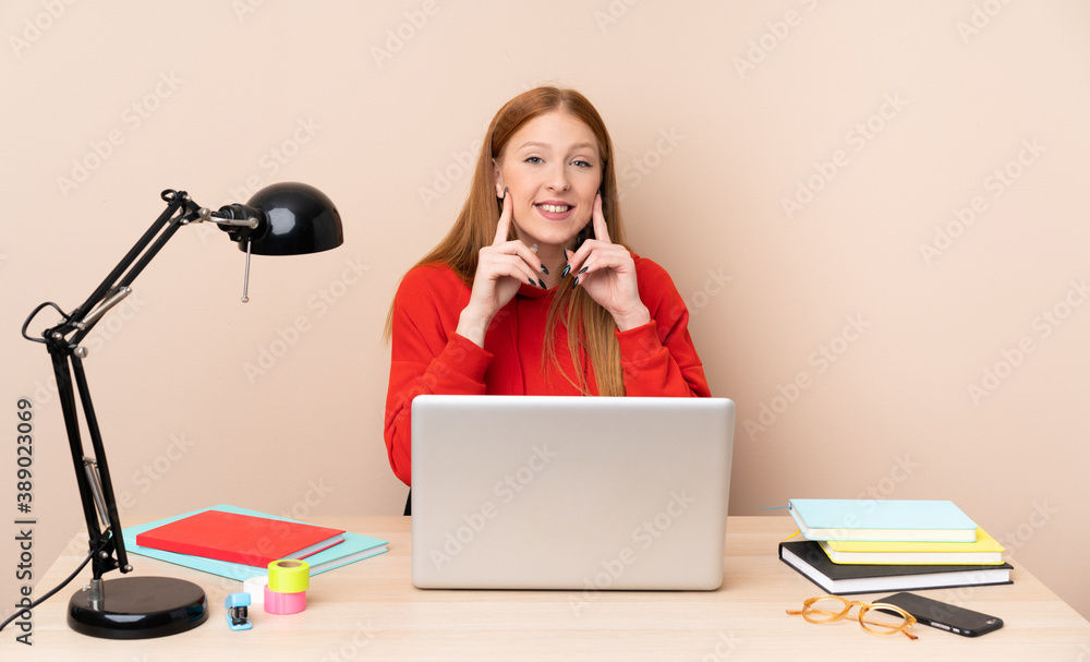 Young student woman in a workplace with a laptop smiling with a happy and pleasant expression Young student woman in a workplace with a laptop smiling with a happy and pleasant expression