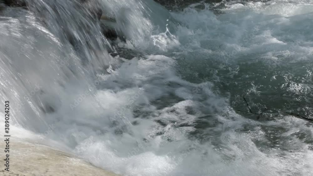 The flowing stream of a waterfall in Thailand. The flowing stream of a waterfall in Thailand.