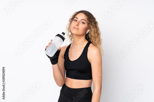 Young sport woman isolated on white background with sports water bottle