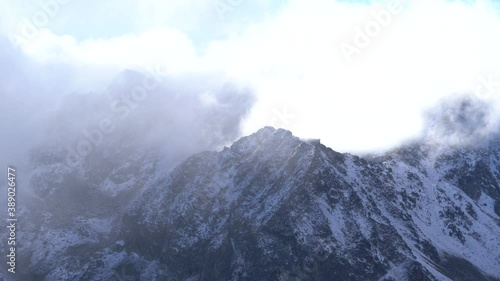 Rocky mountain ridge covered with snow photo