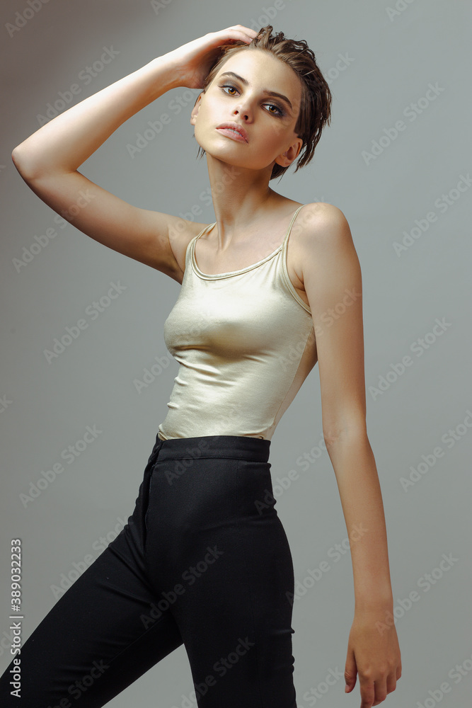 Fototapeta premium Attractive young woman in tight t-shirt and pants