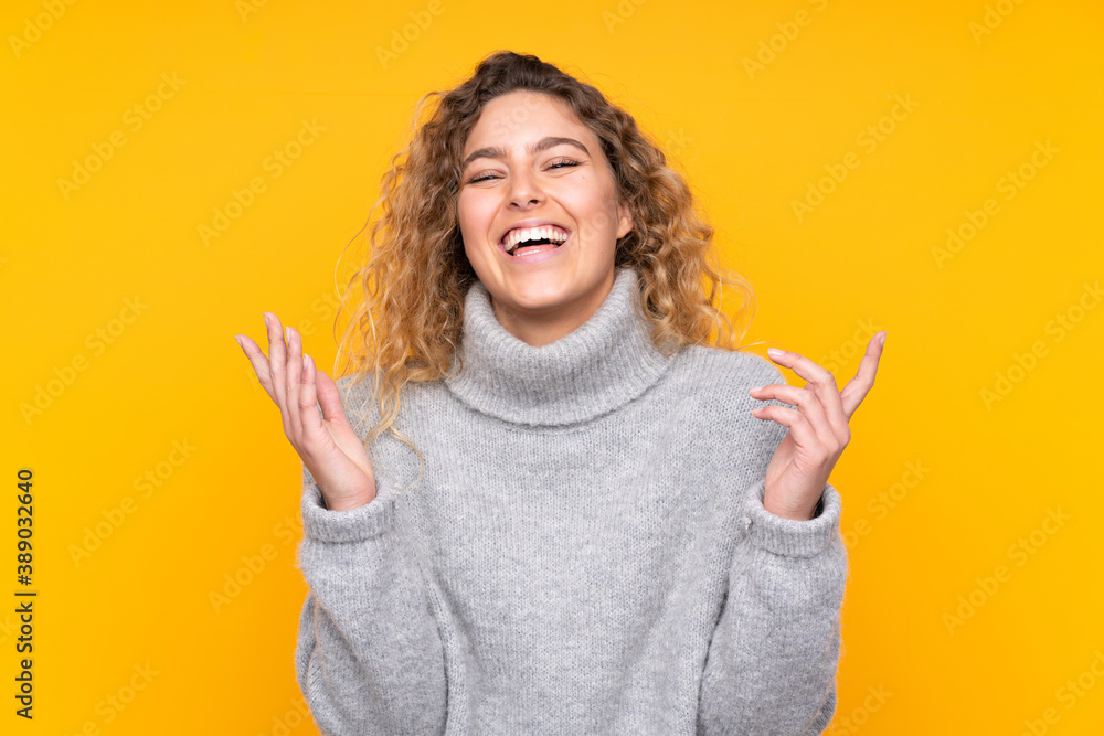 Young blonde woman with curly hair wearing a turtleneck sweater isolated on yellow background smiling a lot Young blonde woman with curly hair wearing a turtleneck sweater isolated on yellow background smiling a lot