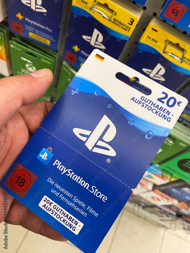 Viersen, Germany - July 9. 2020: View on playstation gift voucher card hold  by hand in german supermarket (focus on card) Stock Photo | Adobe Stock