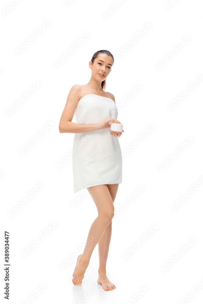 Beautiful woman with mouisturizer isolated on white background. Beauty, cosmetics, spa, depilation, treatment and health concept. Fit and sportive, sensual body with well-kept skin in towel. Copyspace Beautiful woman with mouisturizer isolated on white background. Beauty, cosmetics, spa, depilation, treatment and health concept. Fit and sportive, sensual body with well-kept skin in towel. Copyspace